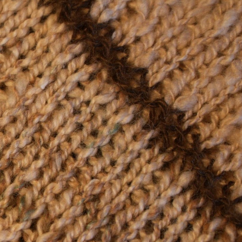 A close up of the shawl showing the brown accents against the cream coloured body