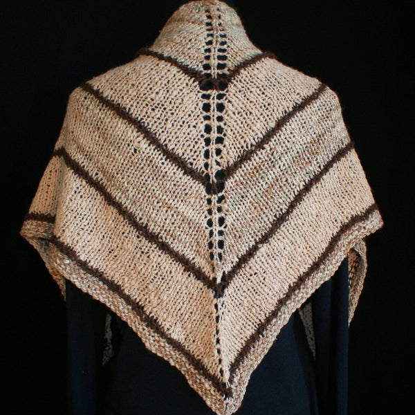 Back view of a handspun, handknit shawl on a black clad mannequin on  a black background